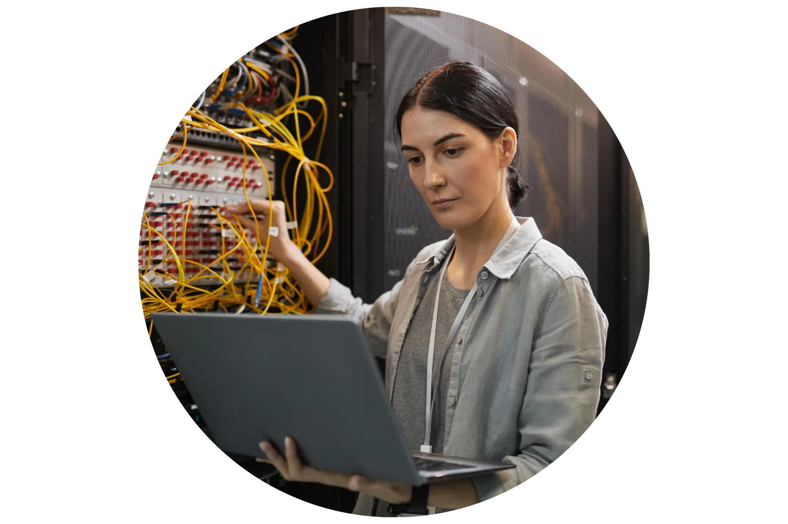 Female Network Technician Inspecting Servers in Data Center