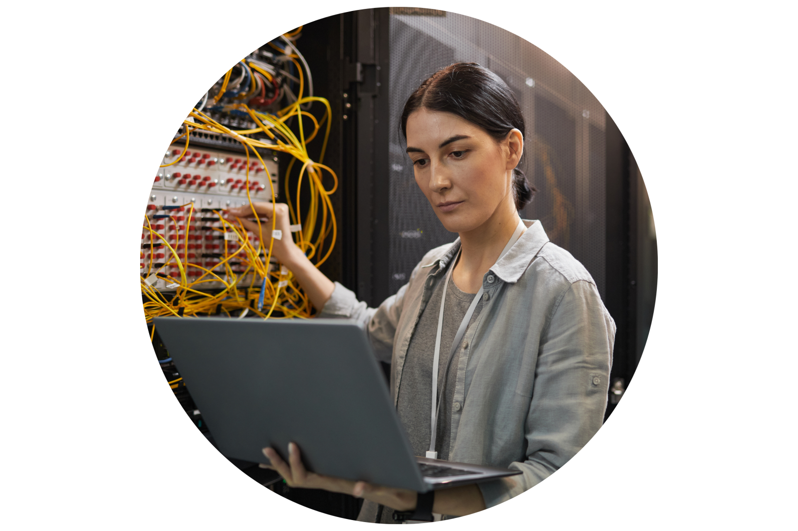 Female Network Technician Inspecting Servers in Data Center