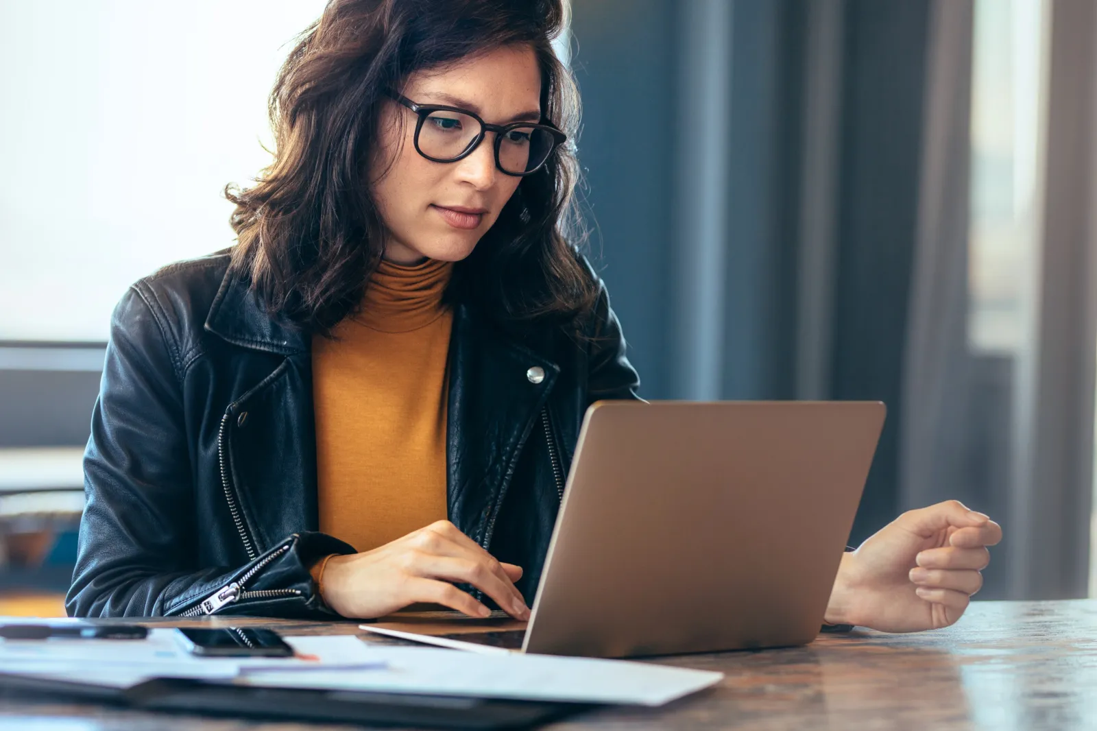 female working on a computer while sitting at a desk