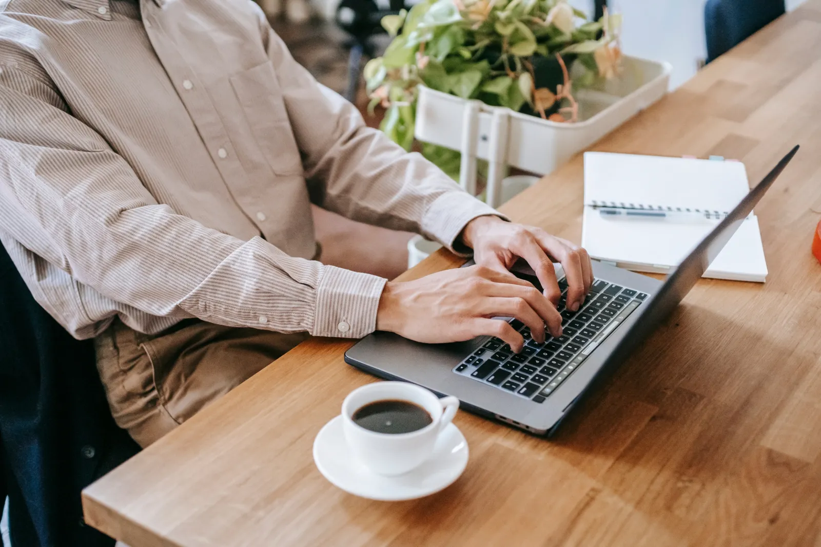 male hands typing on a computer while sitting at a desk