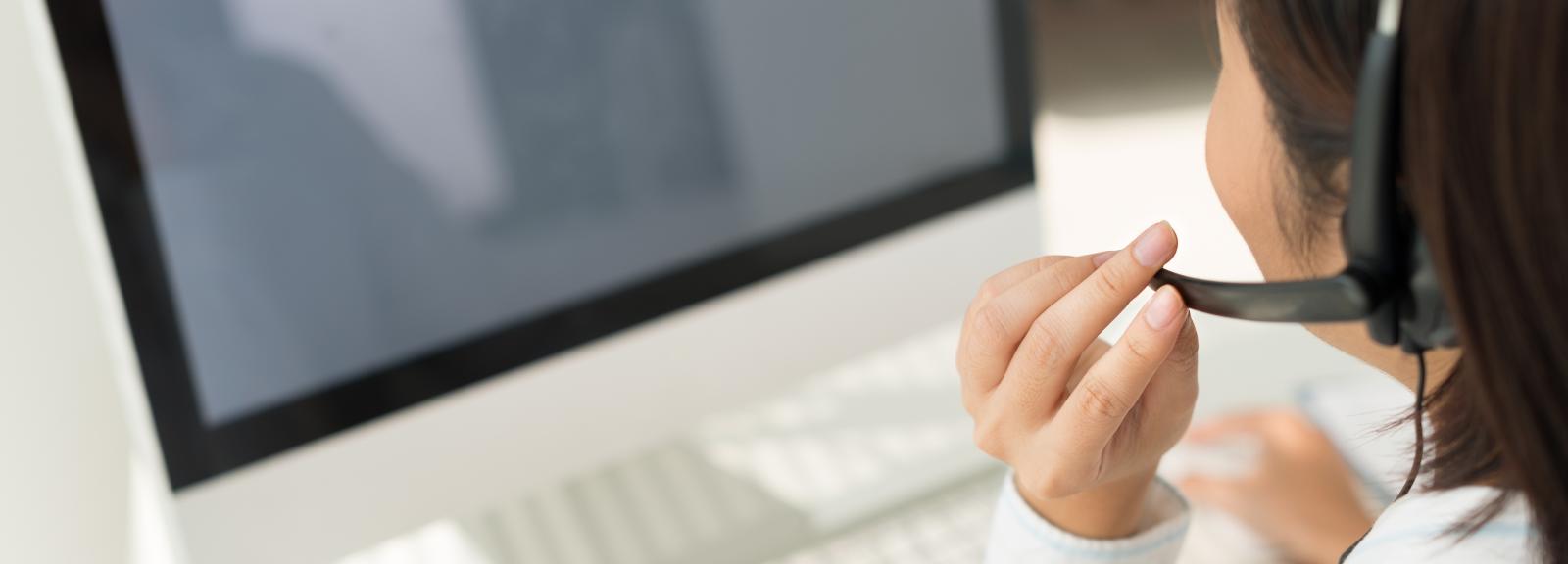 female on the phone and working on a computer