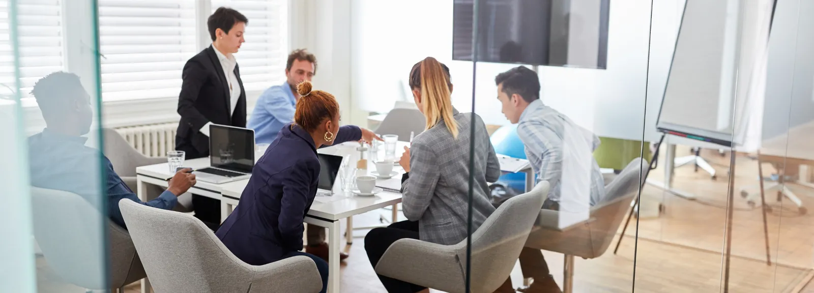 group of employees around a table in a meeting