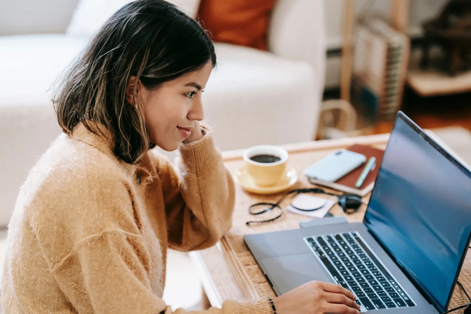 female sitting at a desk on her computer