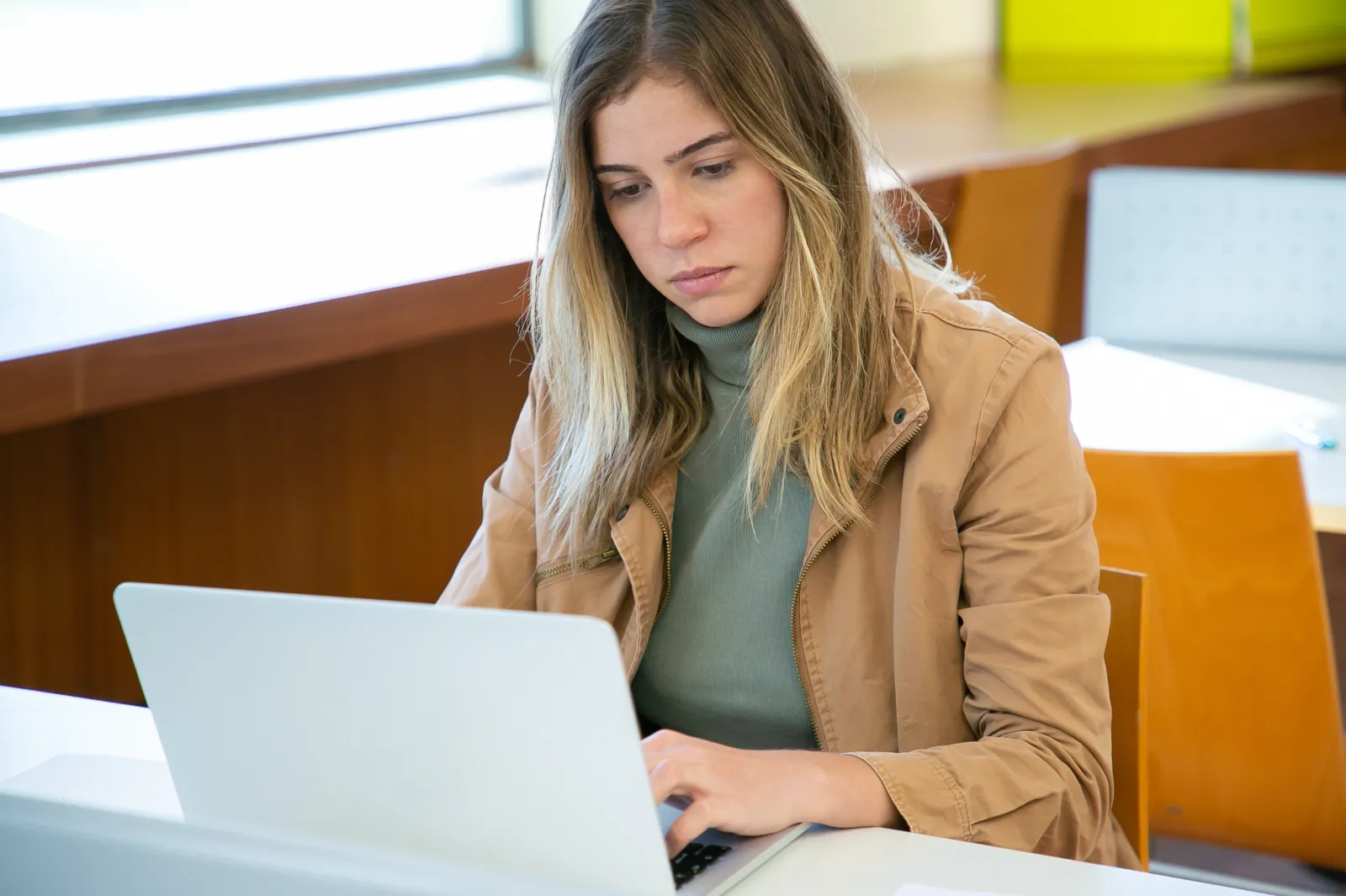 female learning on computer sitting at a desk