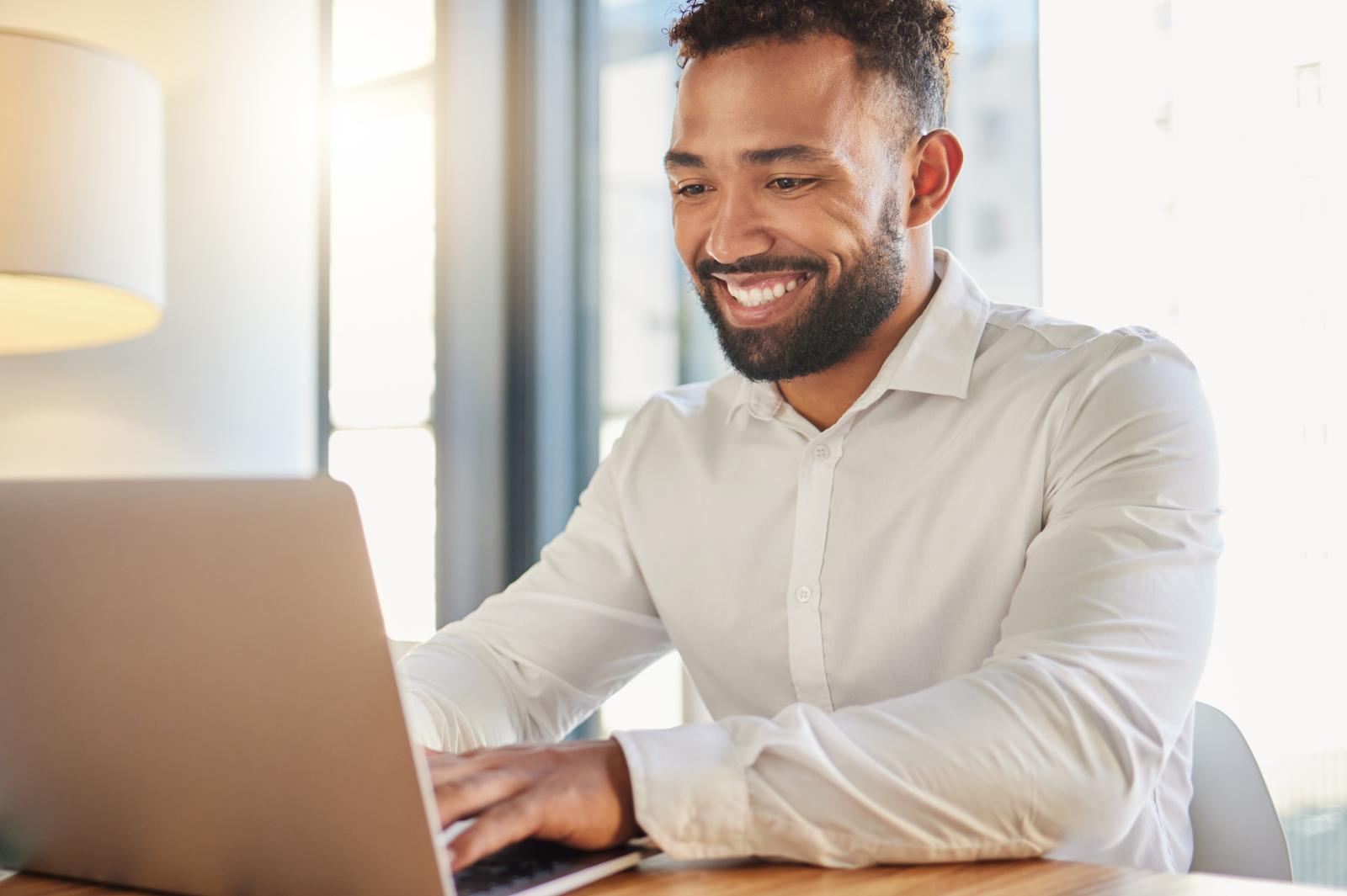 male working on laptop at a desk