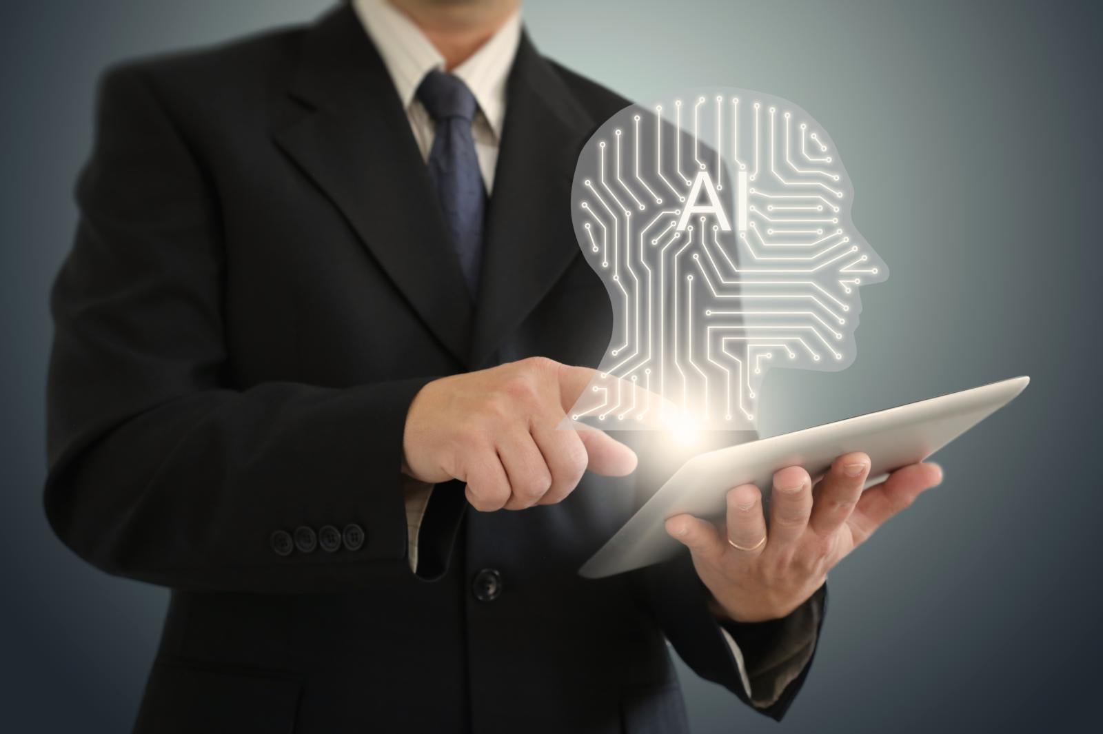 Person on an iPad with a digital AI graphic floating above the iPad. 