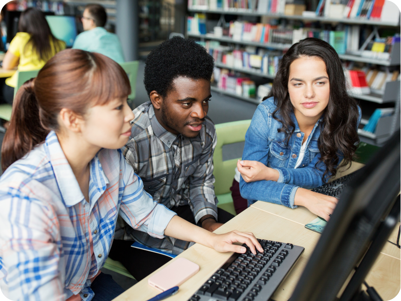 Image of three students looking at a computer