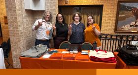 Image of 4 Enterprise Technology staff members standing at a table