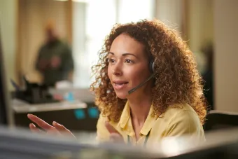Female on the phone at a computer