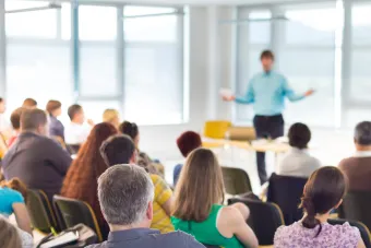 Conference- male speaking to group of people