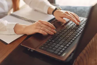 hands typing on a computer