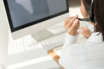 Female on the phone at a computer