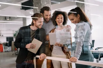 group of professionals collaberating in front of a computer