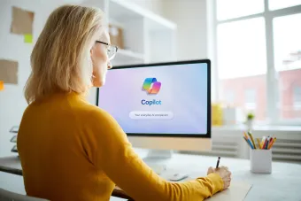 Female working on computer with CoPilot on the computer screen