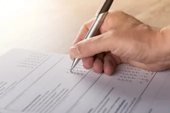 close up of a persons hand taking a servey