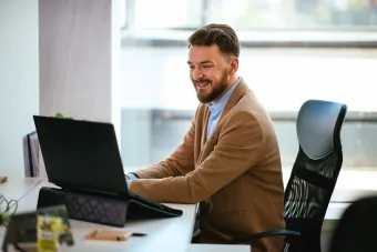 a male working on computer in his office