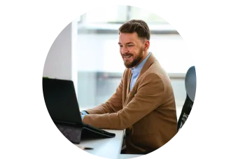 male sitting at a desk on a computer