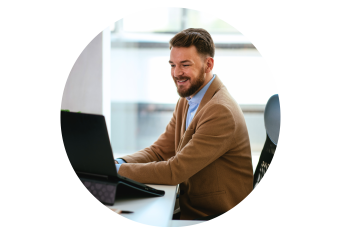 male sitting at a desk on a computer