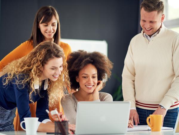 Image of three people around a computer