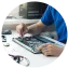 zoomer in image of a persons hands repairing a computer