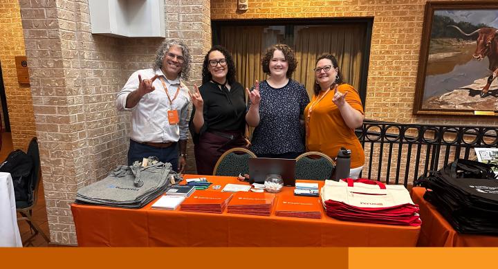 Image of 4 Enterprise Technology staff members standing at a table
