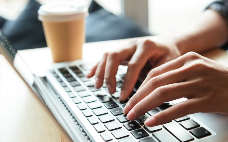person typing on laptop